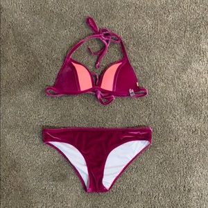 This is a magenta Victoria’s Secret swimsuit